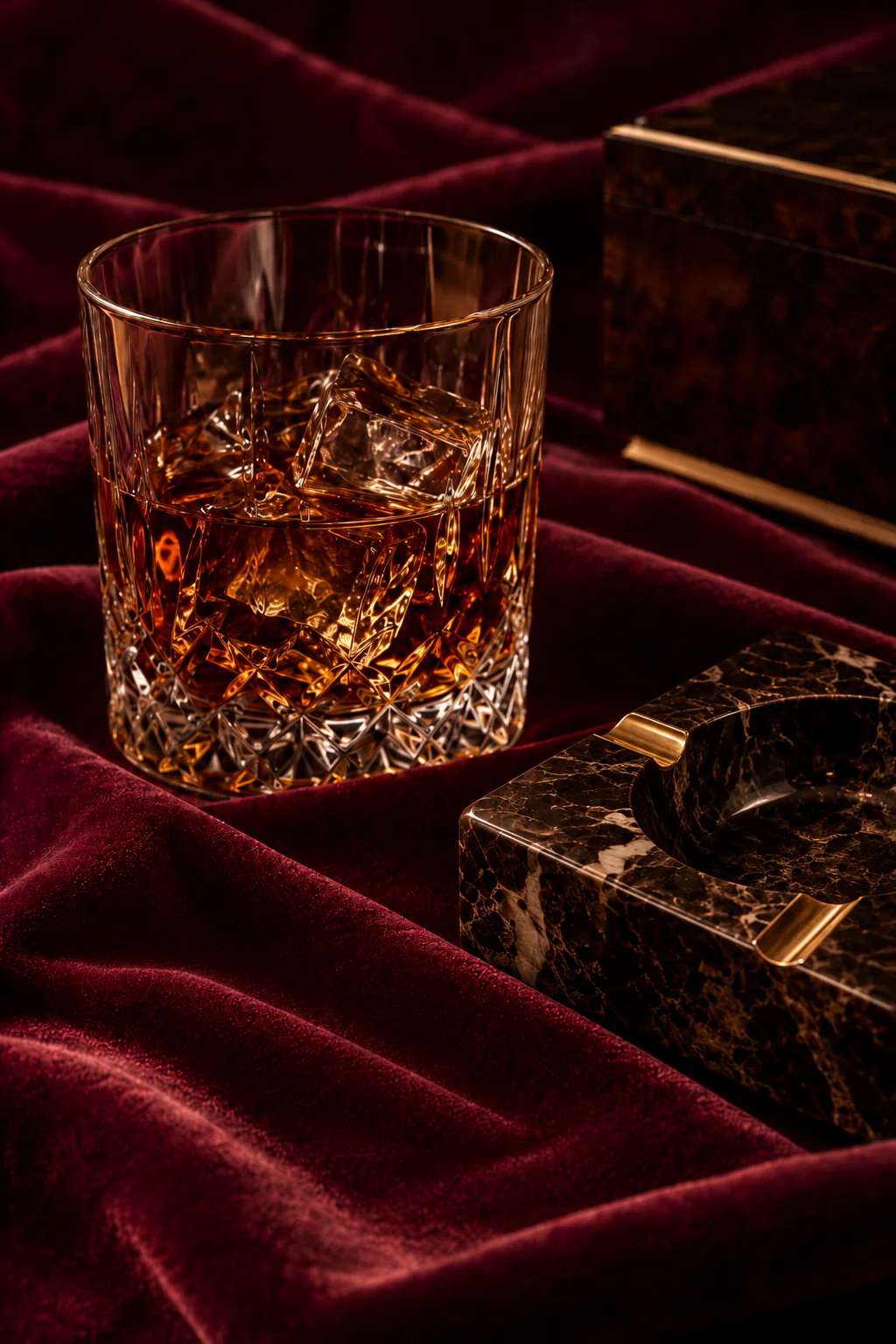 A glass of whisky on burgundy velvet